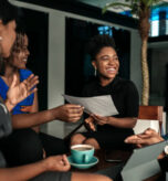 All african casual business meeting. Candid real happy moment between four work colleagues.